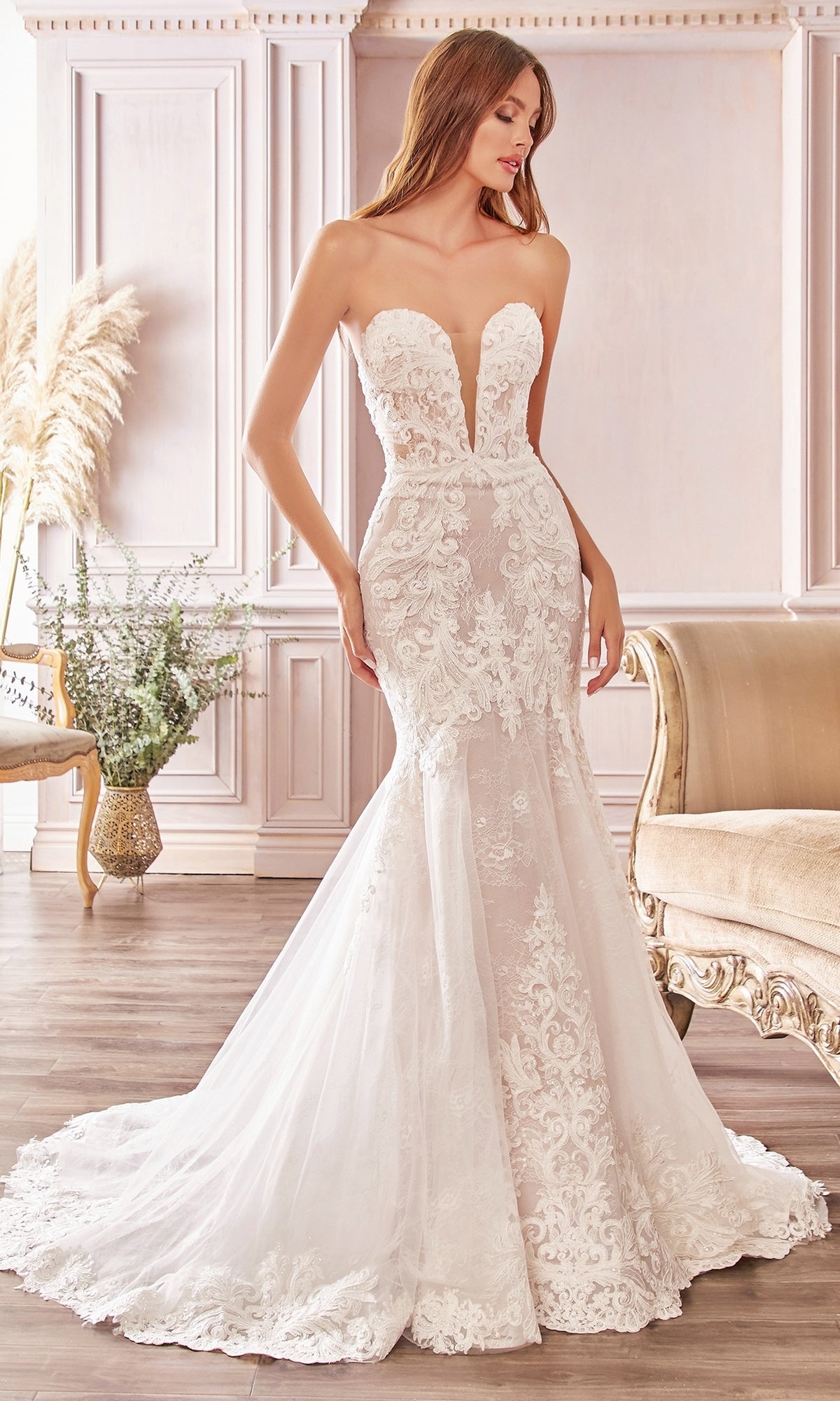 A woman wearing the Ladivine CD928, a strapless mermaid wedding gown.